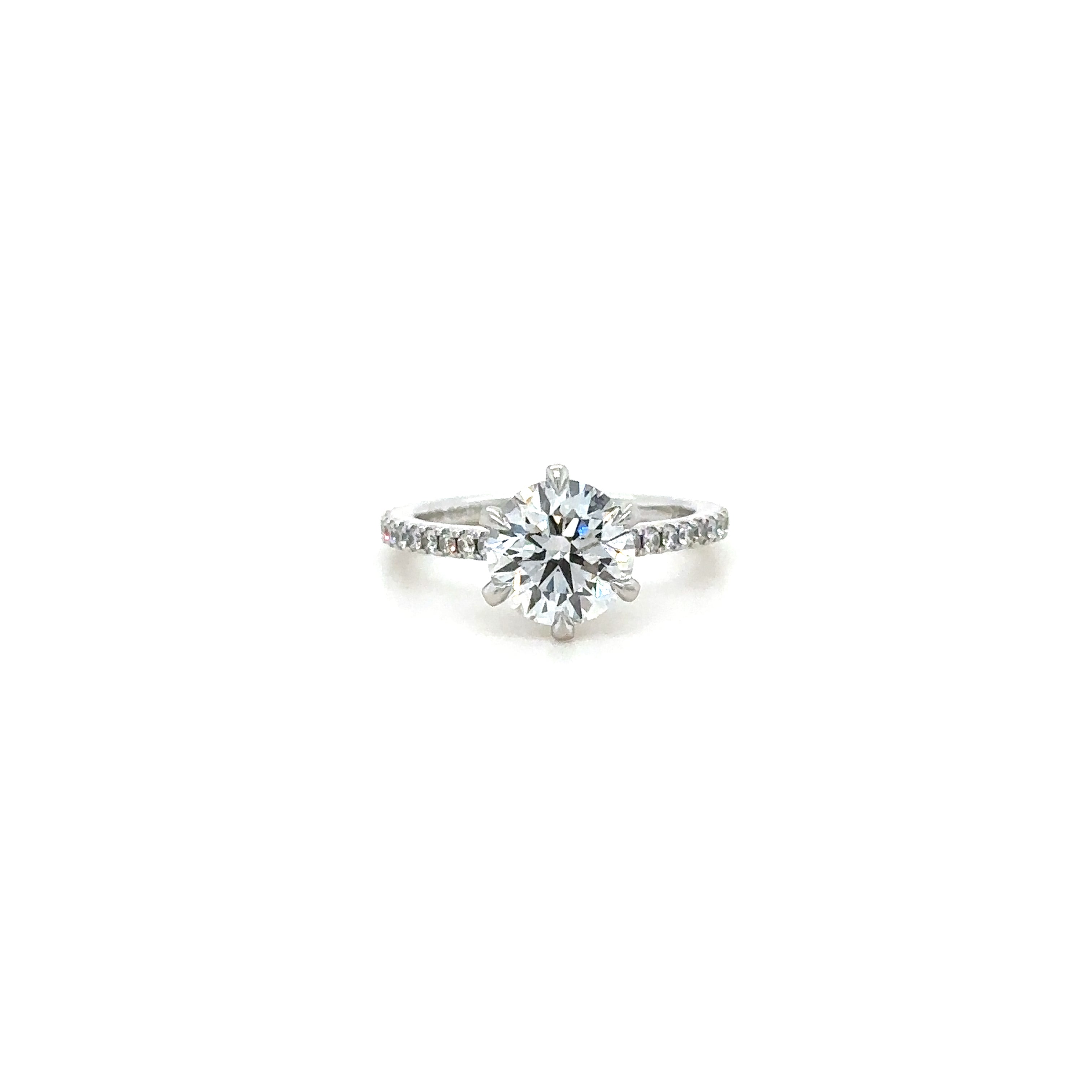 A silver-colored 1.6mm pave gallery diamond ring with a central diamond surrounded by smaller diamonds set in a continuous band. Cathedral Style