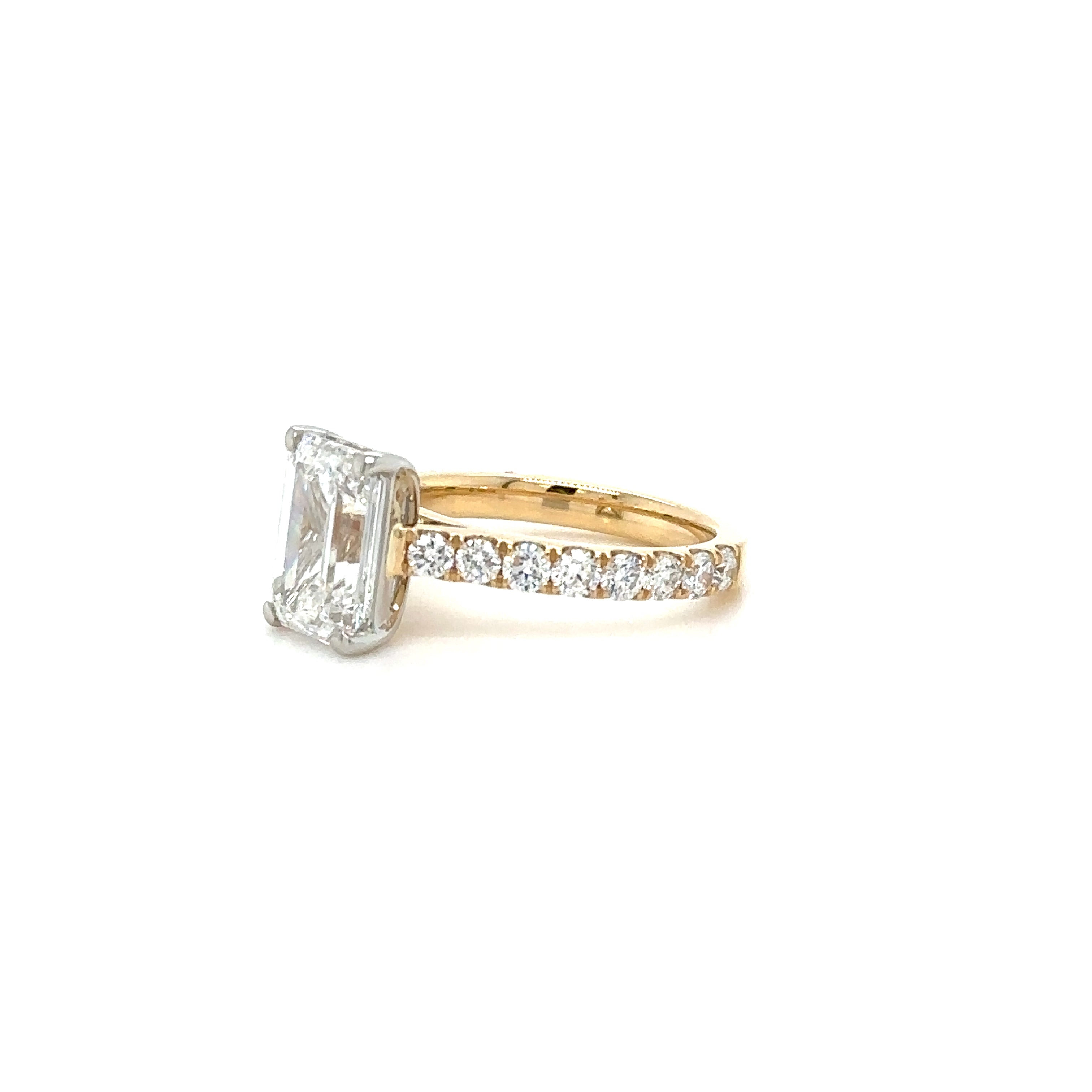 2.2ct Emerald Cut Diamond Ring Set in a 2.5mm Pave gallery diamond ring. Partial Side View. Cairn Diamonds.